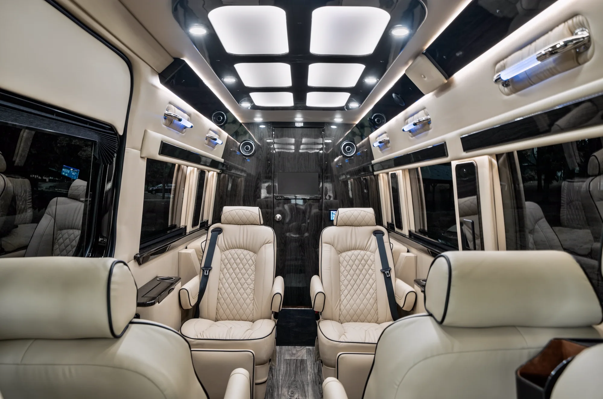 Jet-Style Sprinter interior with captain's chairs and lap tables